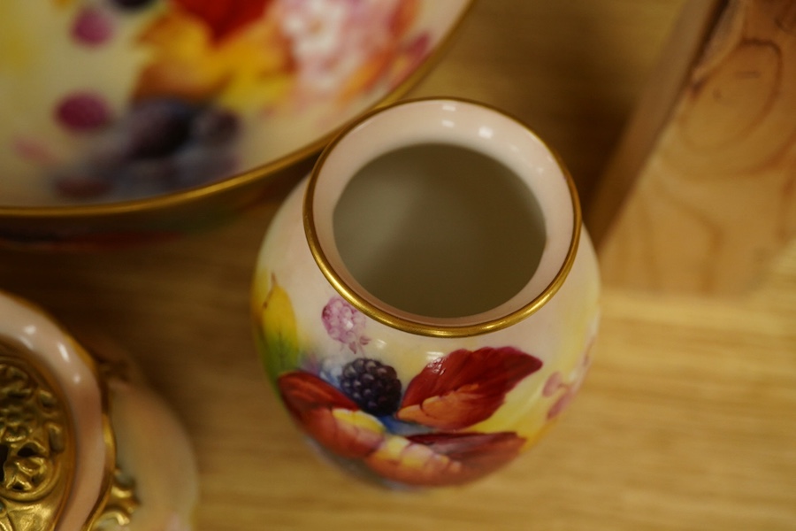 Four pieces of Royal Worcester porcelain hand painted with fruit and flowers by Kitty Blake, largest 18cm wide. Condition - good, bowl with hairline crack